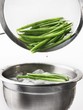 Blanched beans being quenched in iced water