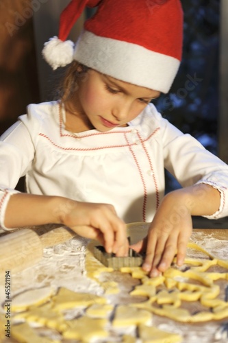 Photo: Girl cutting out biscuits Girl cutting out biscuits