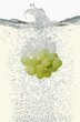 Grapes falling into champagne