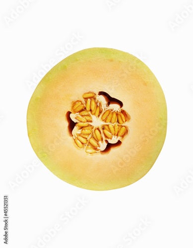 Photo: Half of a Cantaloupe Melon with Seeds; White Background Half of a Cantaloupe Melon with Seeds; White Background