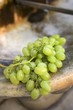 Fresh green grapes on a stone sink