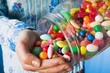 Person tipping sweets out of jar