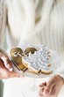 Photo: Hands holding glass bowl of assorted gingerbread biscuits Hands holding glass bowl of assorted gingerbread biscuits