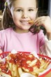 Girl eating chips with ketchup