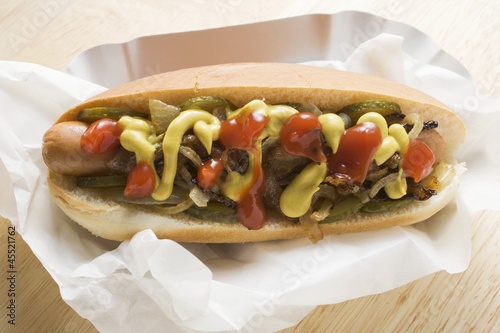 Photo: Hot dog with mustard, ketchup, gherkins and onions Hot dog with mustard, ketchup, gherkins and onions