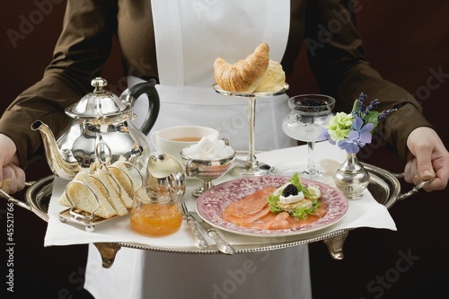 Photo: Chambermaid serving luxury breakfast tray Chambermaid serving luxury breakfast tray