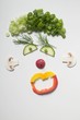 Amusing face made from vegetables, dill and mushrooms