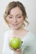 Photo: Woman holding green apple Woman holding green apple