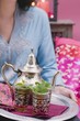 Woman serving peppermint tea on tray