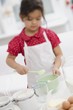 Small girl making dough