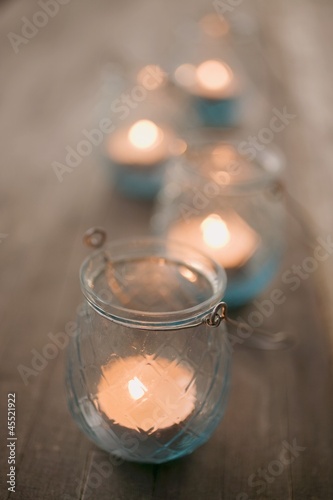 Photo: Windlights on wooden table Windlights on wooden table