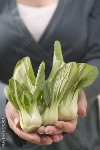 Photo: Woman holding fresh pak choi Woman holding fresh pak choi