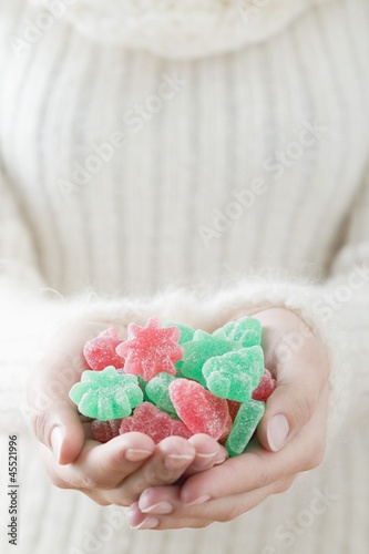 Photo: Woman holding sugar-coated jelly sweets (Christmas) Woman holding sugar-coated jelly sweets (Christmas)