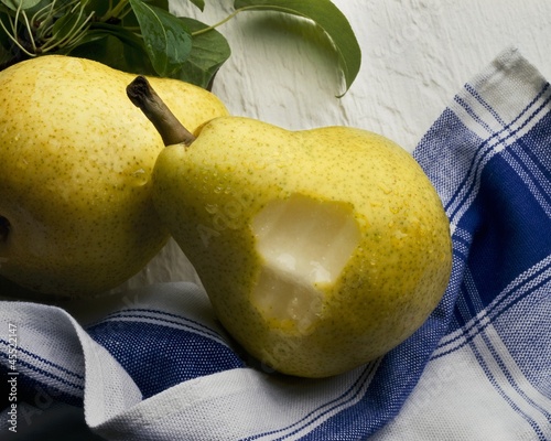 Photo: Two Pears on Dish Towel, One with Bite Taken Out Two Pears on Dish Towel, One with Bite Taken Out