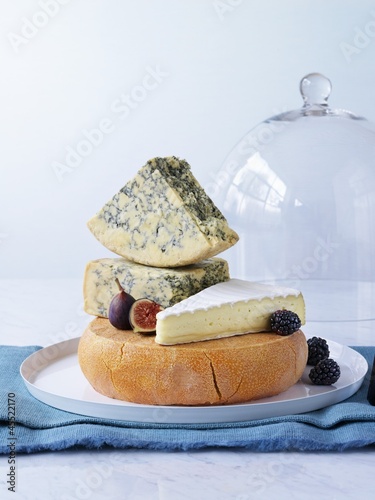 Photo: Various cheeses on cheese platter with figs, blackberries Various cheeses on cheese platter with figs, blackberries