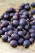Lots of damsons on a wooden surface