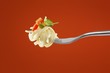 Pasta with vegetables on a fork