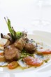 Lamb chops on tomatoes and potatoes with basil