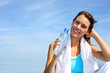Thirsty fitness girl holding bottle of water