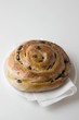 Raisin roll with paper napkin on plate