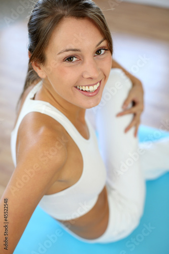 Photo: Beautiful woman exercising in gym Beautiful woman exercising in gym