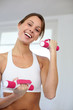 Fitness girl lifting dumbbells in gym