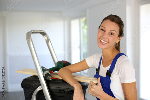 Photo: Cheerful young woman ready to reform house Cheerful young woman ready to reform house