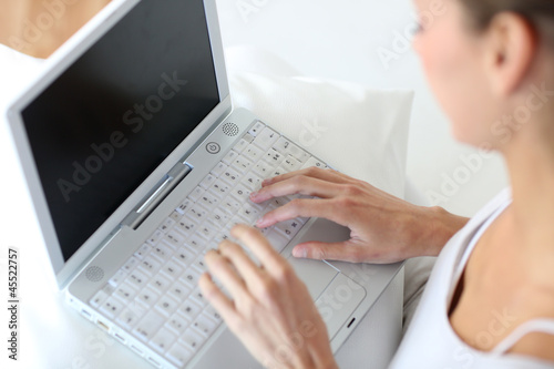 Photo: Closeup of woman using laptop computer Closeup of woman using laptop computer