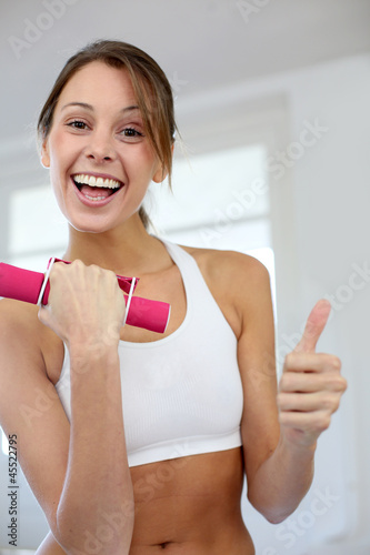 Photo: Fitness girl lifting dumbbells in gym Fitness girl lifting dumbbells in gym