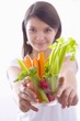 Girl holding a bowl of vegetable sticks with radishes