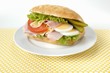 Ham, cheese, egg, tomato and gherkins in ciabatta