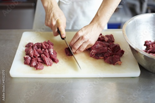 Photo: Chef cutting up beef Chef cutting up beef