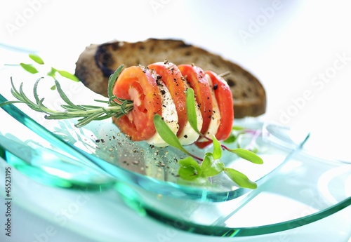 Photo: Tomato slices and mozzarella on rosemary skewer Tomato slices and mozzarella on rosemary skewer