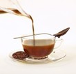 Photo: Cocoa Infused Tea; Chocolate Infused Rooibos Tea with Loose Tea Leaves on Saucer; Chocolate Spoon Cocoa Infused Tea; Chocolate Infused Rooibos Tea with Loose Tea Leaves on Saucer; Chocolate Spoon
