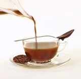 Photo: Cocoa Infused Tea; Chocolate Infused Rooibos Tea with Loose Tea Leaves on Saucer; Chocolate Spoon Cocoa Infused Tea; Chocolate Infused Rooibos Tea with Loose Tea Leaves on Saucer; Chocolate Spoon