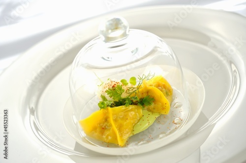 Photo: Ravioli filled with king crab under a glass cloche on a glass plate Ravioli filled with king crab under a glass cloche on a glass plate