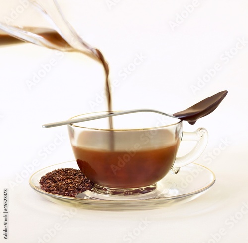 Photo: Cocoa Infused Tea; Chocolate Infused Rooibos Tea with Loose Tea Leaves on Saucer; Chocolate Spoon Cocoa Infused Tea; Chocolate Infused Rooibos Tea with Loose Tea Leaves on Saucer; Chocolate Spoon