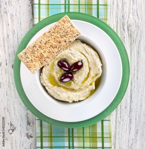 Photo: Hummus with Olive Oil and Olives in a Bowl with Sesame Seed Flat Bread Hummus with Olive Oil and Olives in a Bowl with Sesame Seed Flat Bread
