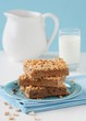 Three slices of peanut cake tray bake on a plate