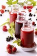 A raspberry smoothie, a redcurrant smoothie and a strawberry smoothie