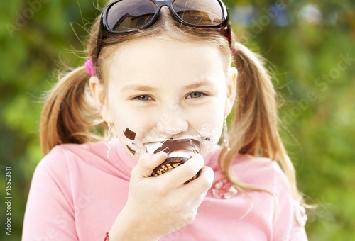 Photo: A girl eating a chocolate marshmallow A girl eating a chocolate marshmallow