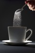 Pouring Spoonful of Sugar into a Coffee Mug