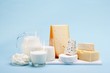 Photo: Various milk products (cheese, yoghurt, quark, milk) on a blue background Various milk products (cheese, yoghurt, quark, milk) on a blue background