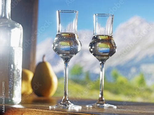 Photo: Two glasses of William's pear schnapps against an alpine backdrop Two glasses of William's pear schnapps against an alpine backdrop