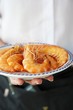 A waitress serving a plate of king prawns