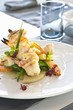 Prawns and monk fish kebabs on a bed of vegetables