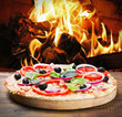 pizza with ham and cheese cooked on the fire