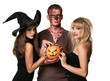 vampire, zombie and witch holding a pumpkin