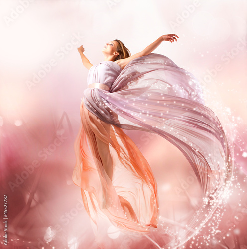 Photo: Fairy. Beautiful Girl in Blowing Dress Flying. Magic Fairy. Beautiful Girl in Blowing Dress Flying. Magic