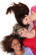Three female friends laying next to each other